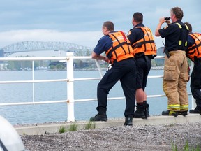Sarnia firefighters continued to search the St. Clair River near Ferry Dock Hill following reports that someone jumped from the Canadian side of the Blue Water Bridge. BRENT BOLES/THE OBSERVER/QMI AGENCY