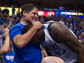 Mavericks owner Mark Cuban hugs Dallas centre DeJuan Blair during the second half against the Spurs in Game 6 of first round playoff action in Dallas on May 2, 2014. (Jerome Miron/USA TODAY Sports)