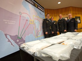 OPP Deputy Commissioner Scott Tod, left, Canada Border Services Agency Director Dan Badour, OPP Detective Inspector Steve Clegg and Waterloo Regional Police Services Inspector David Bishop show off some of the pure cocaine and methamphetamine seized during Project Greymouth, a multi-agency investigation into a smuggling ring involving trafficking Mexican drugs into southwestern Ontario, on display at a press conference at the Ontario Provincial Police Western Region Headquarters in London, Ontario on Thursday May 22, 2014.  OPP have charged 12 people with 49 offences related to drug trafficking rings that were bringing Mexican drugs into southwestern Ontario.  In all, police seized 12 kilograms of cocaine (with an estimated value of $1.2 million), 3.5 kilograms of methamphetamine (with an estimated value of $280,000), a stun gun, $89,955 in Canadian currency and $38,000 in U.S. currency.
CRAIG GLOVER/The London Free Press/QMI Agency