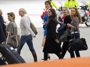 Bouchra van Persie (R), Yolanthe Cabau van Kasbergen (3rd R) and Sylvie van der Vaart (L), the wives and girlfriends of the Netherlands' soccer team, arrive at Schiphol airport in Amsterdam, July 12, 2010. The Dutch lost the final of the 2010 World Cup against Spain. (REUTERS)