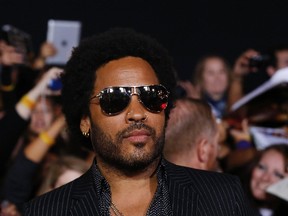 Cast member Lenny Kravitz poses at the premiere of "The Hunger Games: Catching Fire" in Los Angeles, California November 18, 2013. The movie opens in the U.S. on November 22. (REUTERS/Mario Anzuoni)