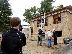 Cole Matthews takes a cell-phone photo of progress on his family's soon-to-be home in Picton. The home is being built through Habitat for Humanity. 
Emily Mountney/The Intelligencer