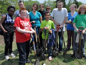 Students from Sir John A. Macdonald public school take a break from tree planting in Sovereign Woods in London, Ont. May 21, 2014. CHRIS MONTANINI\LONDONER\QMI AGENCY