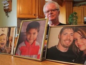 Jim Switzer poses with family photos in his Corunna home. His son Steven, pictured here with his partner Karla, died after an altercation in a Wallaceburg bar in April 2010. He is fighting for justice for his son who left behind two of his own sons, Cole and Steven Jr. (BARBARA SIMPSON, The Observer)