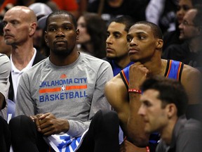 Oklahoma City Thunder forward Kevin Durant (left) and guard Russell Westbrook (right) watch from the bench against the San Antonio Spurs in Game 2. (Soobum Im-USA TODAY Sports)