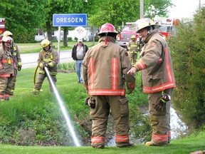 Firefighters from Dresden Station No. 6 responded to a call about a strong odour coming from a drainage ditch on North Street Thursday evening, May 22, 2014. (Peter Epp, QMI Agency)