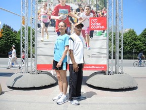 Eleanor Thomas (left) and Mehdi Jaouhar were the winners of the first Ottawa marathon 40 years ago. They were reunited Thursday at Ottawa City Hall's Festival Plaza. TIM BAINES/OTTAWA SUN