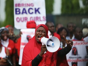 A protester addresses the "Bring Back Our Girls" protest group as they march to the presidential villa to deliver a protest letter to Nigeria's President Goodluck Jonathan in Abuja, calling for the release of the Nigerian schoolgirls in Chibok who were kidnapped by Islamist militant group Boko Haram, May 22, 2014. (REUTERS/Afolabi Sotunde)