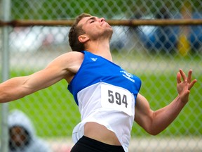 Noah Rolph throws to victory in the senior boys? discus, above, and javelin, inset, on Day 1 of the WOSSAA track and field meet at TD stadium at Western University on Thursday. Rolph set personal bests in both events. (MIKE HENSEN, The London Free Press)