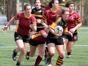 Erica McDade of the La Salle Black Knights tries to get past a group of Regiopolis Panthers tacklers during the Kingston Area Secondary Schools Athletic Association girls rugby championship game at Nixon Field on Thursday. (IAN MACALPINE /THE WHIG-STANDARD)