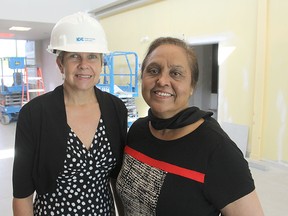 Sandy Sheahan, left, capital build project director for the new Kingston Community Health Centres' building, and executive director Hersh Sehdev stand in the partially completed entrance to the Weller Avenue site.