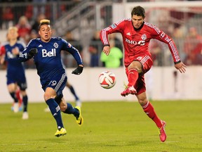 Toronto FC's Mark Bloom (right) in action against Vancouver (USA Today Sports)