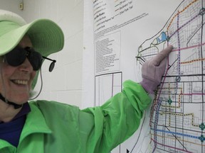 Sarnia cyclist Nora Hope points out her typical route on a city bike lane map at a public meeting held at Clearwater Arena Thursday night. City staff held the open house to receive feedback on a draft transportation/transit master plan calling for millions of dollars worth of upgrades to the city's infrastructure. (BARBARA SIMPSON, The Observer)