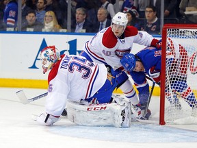 Montreal Canadiens goalie Dustin Tokarski covers the puck as defenceman Nathan Beaulieu pushes New York Rangers right wing Derek Dorsett during Game 3 of the NHL Eastern Conference final at Madison Square Garden in New York, May 22, 2014. (ANDY MARLIN/USA Today)