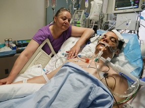 Marge Karabelski keeps vigil over her comatose son Tommy yesterday at St. Mike's Hospital. Tommy, also pictured below, was in town from Detroit visiting his girlfriend when he was partially hit by a TTC subway train at Islington station last Saturday. (VERONICA HENRI/Toronto Sun)