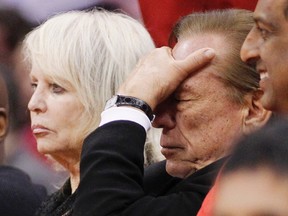 Los Angeles Clippers owner Donald Sterling (R) puts his hand over his face as he sits courtside with his wife Shelly (L) while the Clippers trail the Chicago Bulls in the second half of their NBA basketball game in Los Angeles December 30, 2011. (REUTERS/Danny Moloshok)