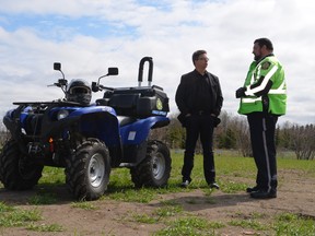 ACICR director Don Voaklander (centre) discussed OHV safety with community patrol officer Mark Elwood (right) on May 16. ACICR estimates Alberta has around 14 OHV-related deaths each year. April Hudson, Reporter/Examiner