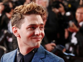 Director Xavier Dolan poses on the red carpet as he arrives for the screening of the film "Mommy" in competition at the 67th Cannes Film Festival in Cannes May 22, 2014. REUTERS/Yves Herman
