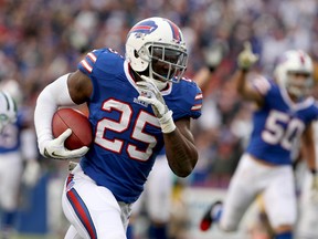 Buffalo Bills strong safety Da'Norris Searcy runs the ball in for a touchdown after an interception during NFL action against the New York Jets at Ralph Wilson Stadium in Orchard Park, N.Y. last November. (Timothy T. Ludwig/USA TODAY Sports/Files)