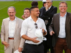 Brazil's Ronaldo (middle) and Sports Minister Aldo Rebelo (left), along with FIFA Secretary General Jerome Valcke, visit the Arena da Baixada stadium in Curitiba April 22, 2014. (REUTERS/Rodolfo Buhrer)