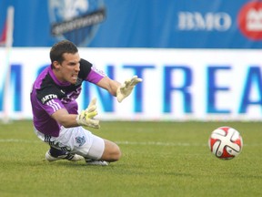 May 14, 2014; Montreal, Quebec, Canada; FC Edmonton goalkeeper John Smits (23) makes a save against Montreal Impact during the first half at the Stade Saputo. Mandatory Credit: Jean-Yves Ahern-USA TODAY Sport