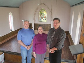 Wilton Community Association secretary Edwin Amell, left, association president Jane McDonald and Loyalist Township councillor Jamie Hegadorn stand inside the newly restored Wilton community hall. (Michael Lea/The Whig-Standard)