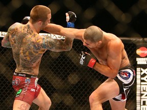 Renan Barao (right) fights Eddie Wineland for the UFC interim bantamweight championship during UFC 165 at the Air Canada Centre in Toronto Saturday September 21, 2013. (Dave Abel/Toronto Sun/QMI Agency)