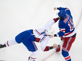 New York Rangers' Brandon Prust fights Canadiens Derek Dorsett while Daniel Carcillo, who would then jostle a linesman and incur a 10-game suspension, looks on. Prust received two games. (QMI AGENCY/PHOTO)