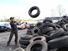 JOHN LAPPA/THE SUDBURY STAR/QMI AGENCY 
Todd Lepage, of Rock City Auto Supplies, tosses a tire onto a tire collection area at the business at 1024 the Kingsway in Sudbury, ON. on Friday, May 23, 2014. From May 26-31, Ontario Automotive Recyclers Association members like Rock City will donate all light truck, passenger and agricultural tire recycling fees to the Sunshine Foundation of Canada for children with severe physical challenges or life-threatening illnesses. Rock City is holding a fundraising barbecue on May 31 from 11 a.m. to 2 p.m.