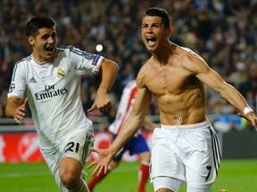 Real Madrid's Cristiano Ronaldo (right) celebrates with teammate Alvaro Morata after scoring against Atletico Madrid during the Champions League final at the Luz Stadium in Lisbon May 24, 2014.      (REUTERS/Kai Pfaffenbach)