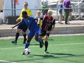 Ottawa Fury FC's Kristy Moore (in black) battles for the ball against a Quebec Dynamo opponent Saturday at Carleton University. Moore scored the first goal in a 2-0 Ottawa win. (Chris Hofley/Ottawa Sun)