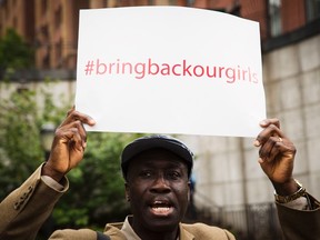 A demonstrator holds a sign above his head while chanting for the release of the Nigerian schoolgirls in Chibok who were kidnapped by Islamist militant group Boko Haram, outside of the United Nations headquarters in New York, May 22, 2014. (REUTERS/Lucas Jackson)