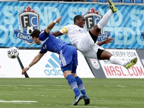 Edmonton FC's Michael Nonni (22) collides with the Atlanta Silverbacks'  Mike Randolph (29) during first half NASL action at Clarke Stadium, in Edmonton Alta., on Saturday May 24, 2014. David Bloom/Edmonton Sun/QMI Agency