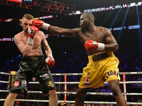 Adonis Stevenson (right) connects to the head of Andrzej Fonfara during their light-heavyweight championship bout Saturday at the Bell Centre in Montreal. (SEBASTIEN ST. JEAN/QMI Agency)