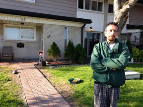 Andy Santos, 58, of Pickering, stands in front of his next-door neighbour's house in a townhouse complex at 925 Bayly St. on Saturday. Police busted a meth lab at Santos' next-door neighbour's house Friday evening. (IRENE THOMAIDIS/Toronto Sun)