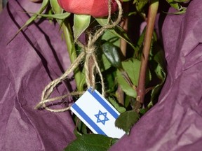 A bouquet of flowers with the Israeli flag, left by a passer-by, is seen at the entrance of the Jewish Museum, the site of a shooting incident, in central Brussels May 25, 2014.  REUTERS/Eric Vidal