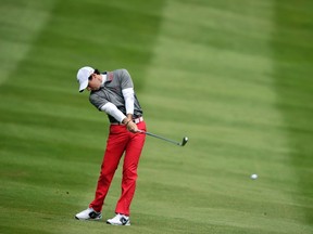 Northern Irish golfer Rory McIlroy plays his approach shot to the 4th green during the final round of the PGA Championship at Wentworth Golf Club in Surrey, England, on May 25, 2014. AFP PHOTO/GLYN KIRK