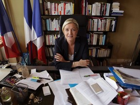 France's far right National Front political party leader Marine Le Pen poses following an interview with Reuters at the party's headquarters in Nanterre, near Paris, May 12, 2014.  REUTERS/Philippe Wojazer