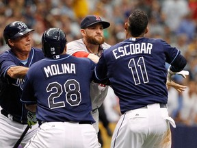 Tampa Bay Rays shortstop Yunel Escobar and Boston Red Sox left fielder Jonny Gomes (second from right) push each other as benches clear AL action Sunday at Tropicana Field. ( Kim Klement/USA TODAY Sports)
