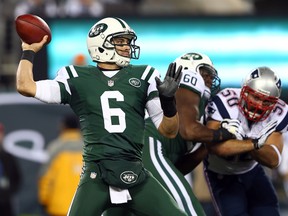 Jets QB Mark Sanchez drops back to pass against the Patriots during NFL action on Nov. 22, 2012 in East Rutherford, N.J. A Jets fan paid $820 for the jersey Sanchez wore when he fumbled the ball crashing into his teammate. (Elsa/Getty Images/AFP/Files)