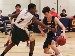 Kingston Impact's Samuel Pierson dribbles past Gloucester Wolverines' Williams Ndikumana during provincial major midget boys Ontario Cup basketball championships in Kingston on the weekend. Julia McKay/The Whig-Standard
