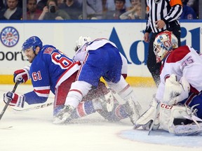 New York Rangers forward Rick Nash (61) tries to get a shot off against Montreal Canadiens centre David Desharnais and goalie Dustin Tokarski (35) during Game 4 of the Eastern Conference final Sunday at Madison Square Garden. (Brad Penner/USA TODAY Sports)