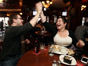 Ryan Ochocki and Sheiny Satanove celebrate an Edmonton Oil Kings goal against the Guelph Storm, as the two watch the Memorial Cup at Hudsons Canadian Tap House, 10307  82 Ave., on Sunday. DAVID BLOOM/Edmonton Sun