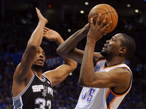 Oklahoma City Thunder’s Kevin Durant (right) shoots against San Antonio Spurs defender Boris Diaw during Game 3 of the Western Conference Finals Sunday at Chesapeake Energy Arena. (Mark D. Smith/USA TODAY Sports