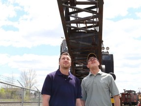 JOHN LAPPA/THE SUDBURY STAR/QMI AGENCY 
Cody Cacciotti, left, of the Northern Ontario Railroad Museum and Heritage Centre, and Randy Gibson examine a Canadian National Rail crane 50392 at an open house at the museum in Capreol, ON. on Saturday, May 24, 2014. The crane and a 1907 Temiskaming and Northern Ontario Railway steam locomotive 219 are part of two new exhibits at the museum. The facility is open seven days a week until September 1. For more info, go to www.normhc.ca, or call 705-858-5050.