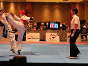 Rachel Irvine of Bluewater Tae Kwon Do (in red) scores a knockout kick in her silver medal match at the Canadian championships May 17. She was one of three Bluewater athletes to place inside the top four in their respective divisions in the tournament. (Submitted photo)