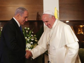 Pope Francis, right, shakes hands with Israel's Prime Minister Benjamin Netanyahu during their meeting at the Notre Dame Center in Jerusalem on May 26, 2014. (REUTERS/Alex Kolomoisky/Pool)