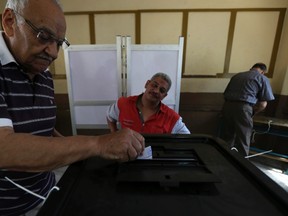 A man casts his ballot on the first day of the presidential elections inside a polling station in Cairo on May 26, 2014. (REUTERS/Amr Abdallah Dalsh)