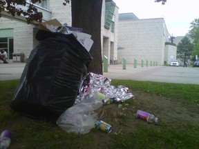 A bag of garbage from the race weekend rests up against a tree outside City Hall during the noon hour Monday, May 26, 2014. JON WILLING/OTTAWA SUN