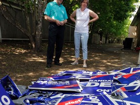 MPP candidate for Ottawa West-Nepean Randall Denley and his wife Linda stand beside vandalized signs at their Ottawa HQ on Monday, May 26, 2014.  Tony Caldwell/Ottawa Sun/QMI Agency